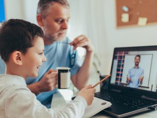 Schoolboy educate online. Father helps his son with home work. Boy in video conference with teacher on laptop at home.  (Schoolboy educate online. Father helps his son with home work. Boy in video conference with teacher on laptop at home. , ASCII, 12